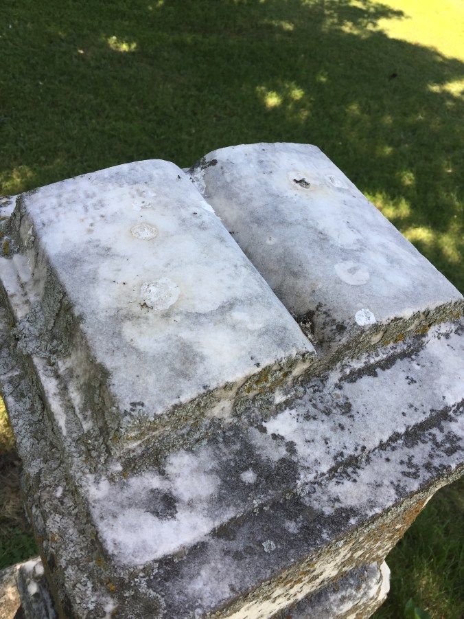 Glenn, Alexander and Sarah headstone has a book on top.